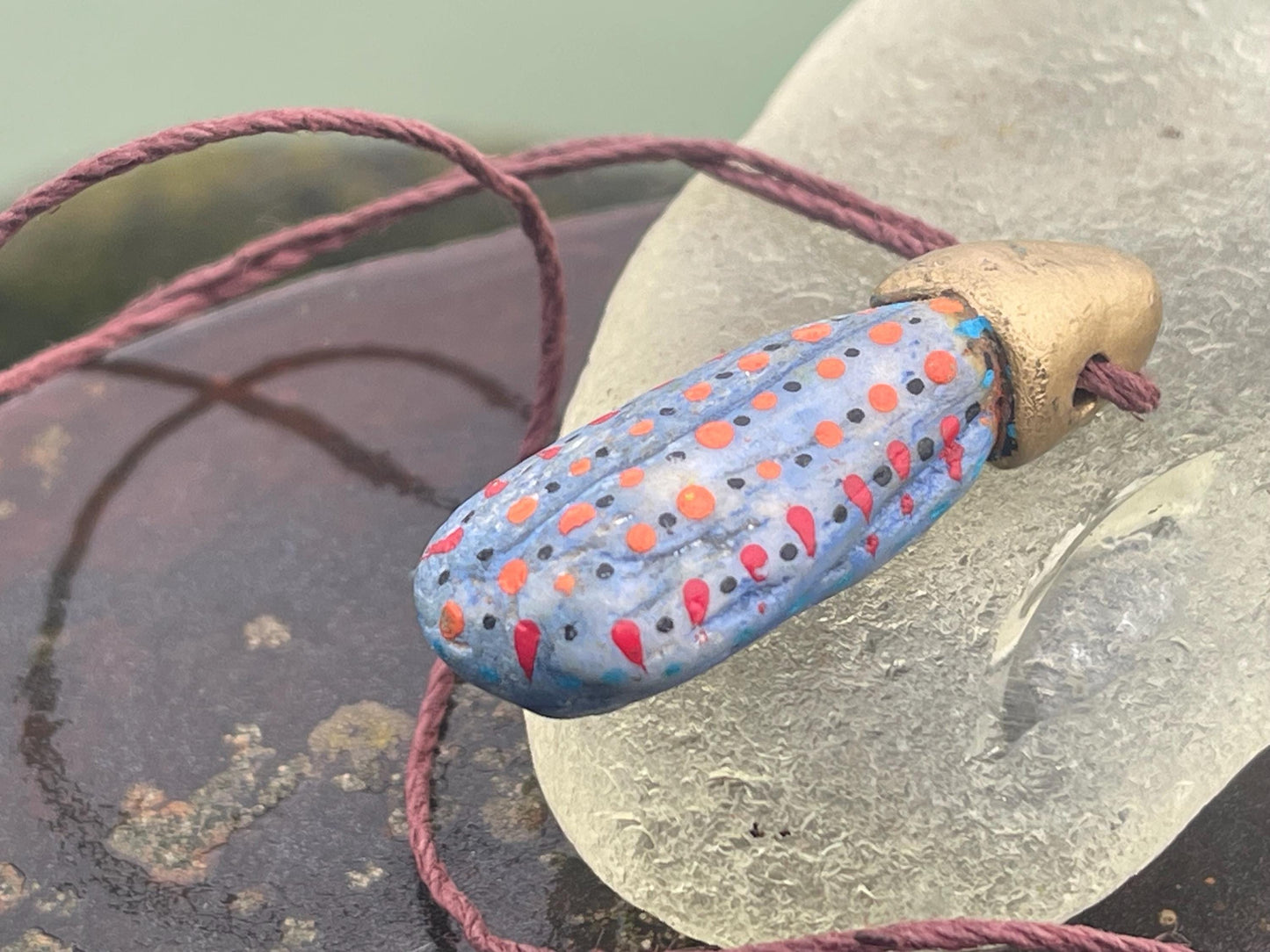 Pebble pendants. Painted pebble necklaces. Hand painted eco friendly necklaces. Eco friendly jewellery. Ethical handmade jewellery.