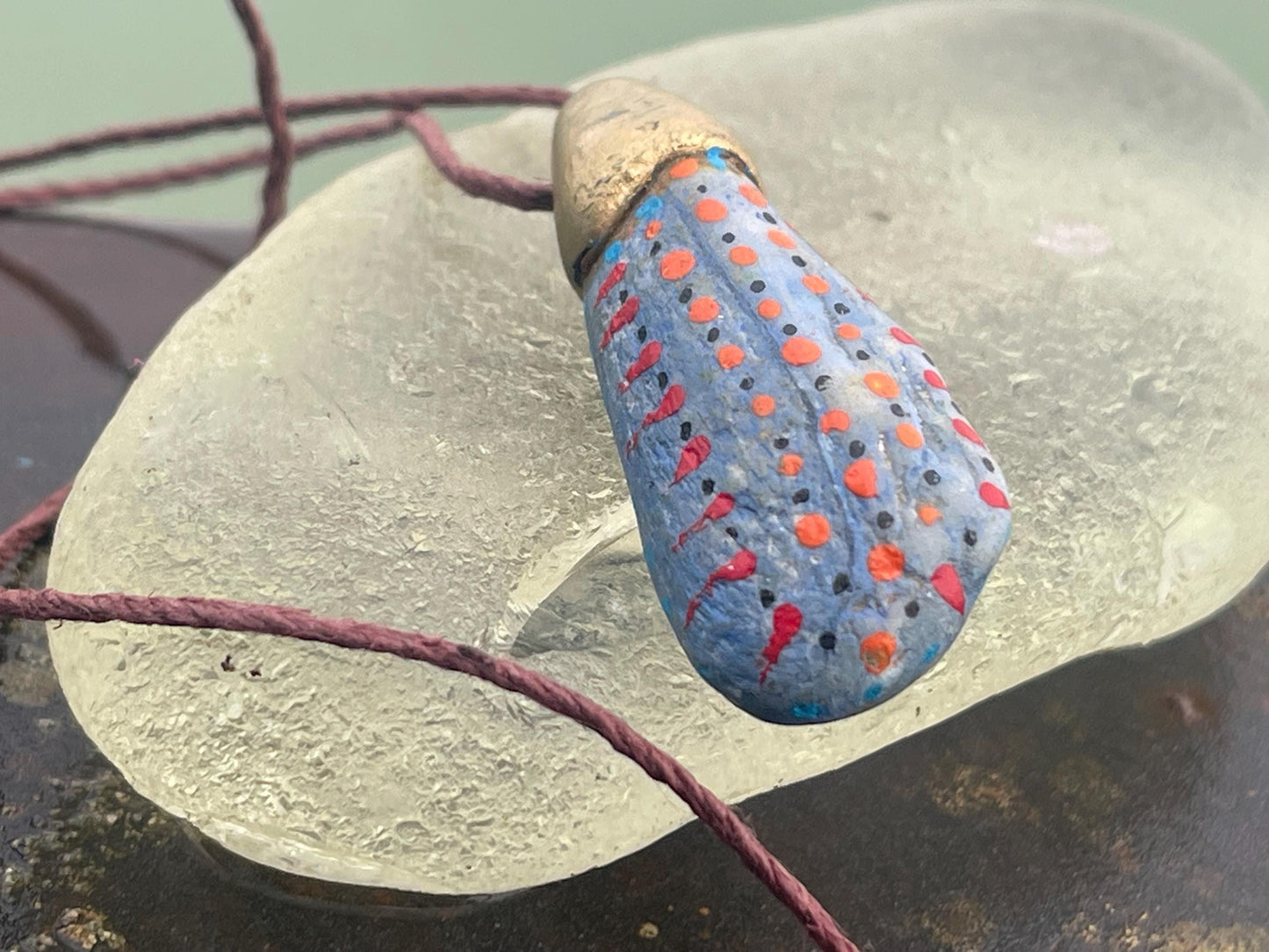 Pebble pendants. Painted pebble necklaces. Hand painted eco friendly necklaces. Eco friendly jewellery. Ethical handmade jewellery.