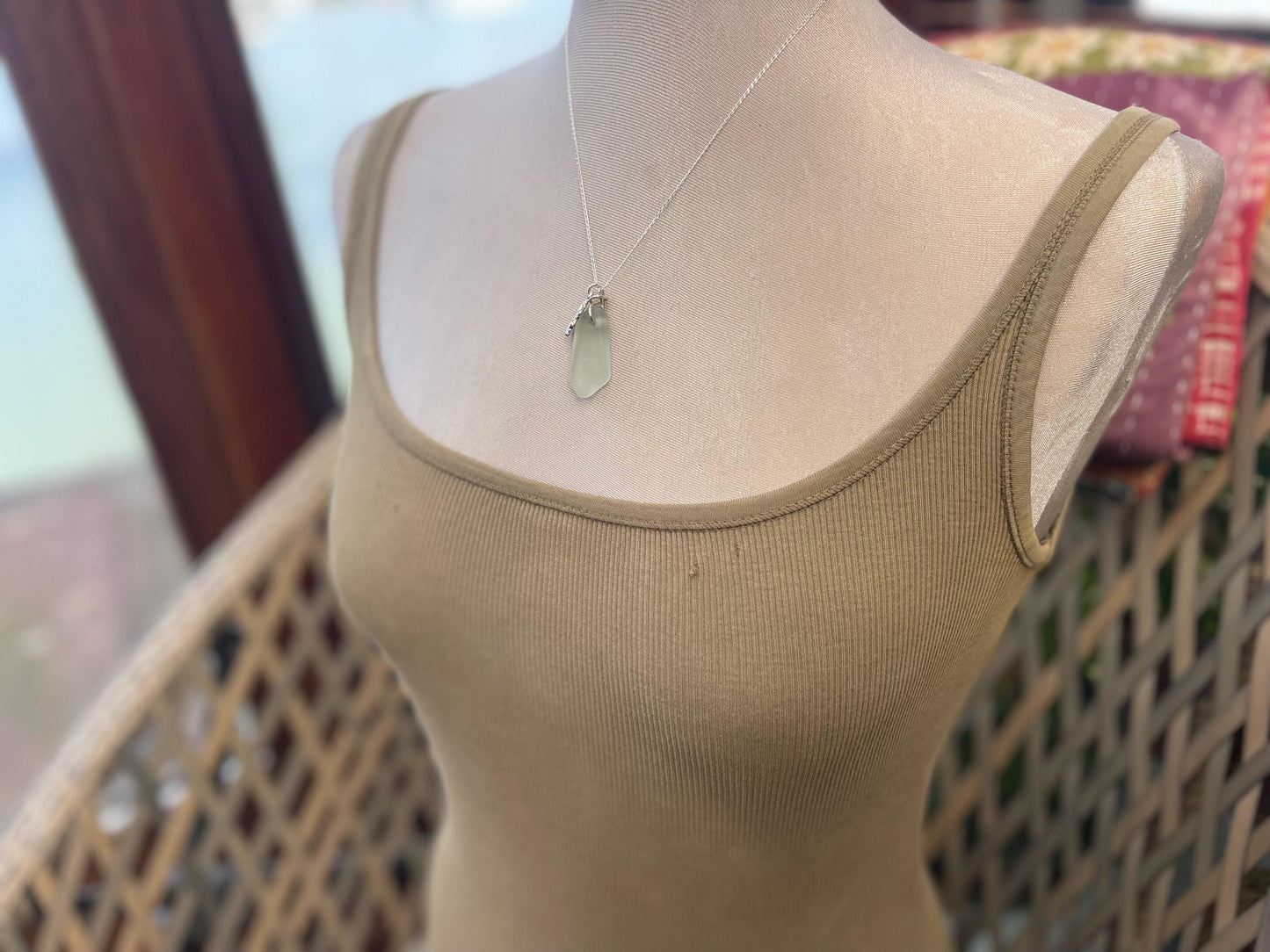 Eco friendly sea glass necklace on a sterling silver chain showcasing a little octopus. Octopus pendant, eco friendly jewellery.