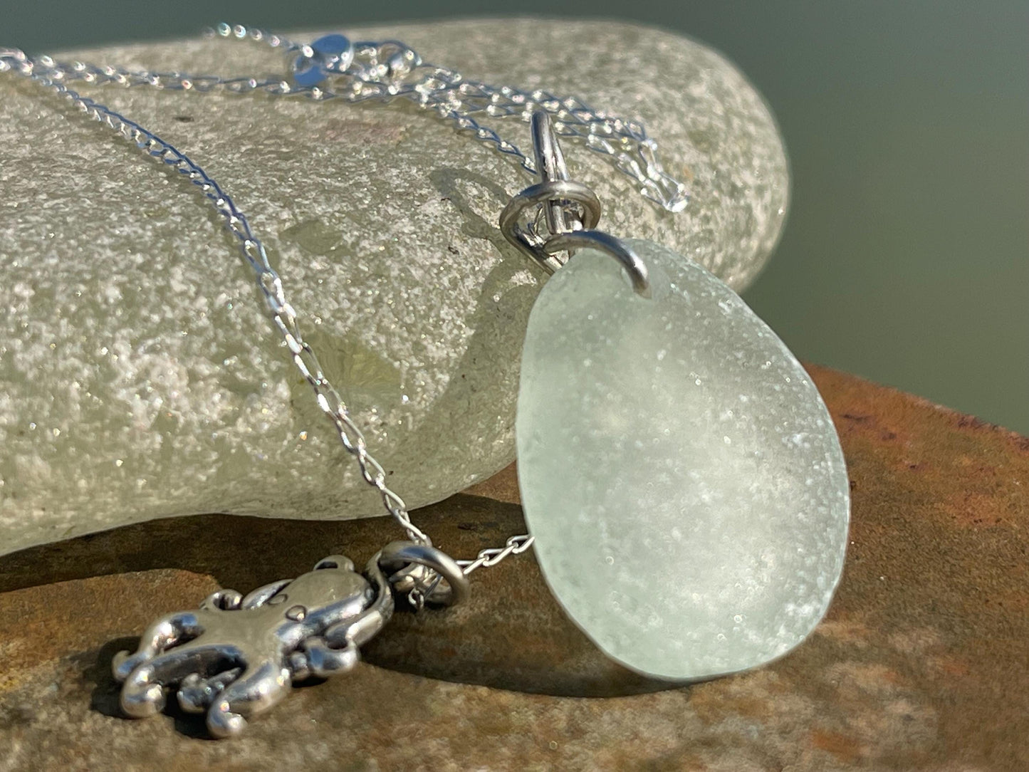 Eco friendly aqua sea glass necklace on a sterling silver chain showcasing a little octopus. Octopus pendant, eco friendly jewellery.