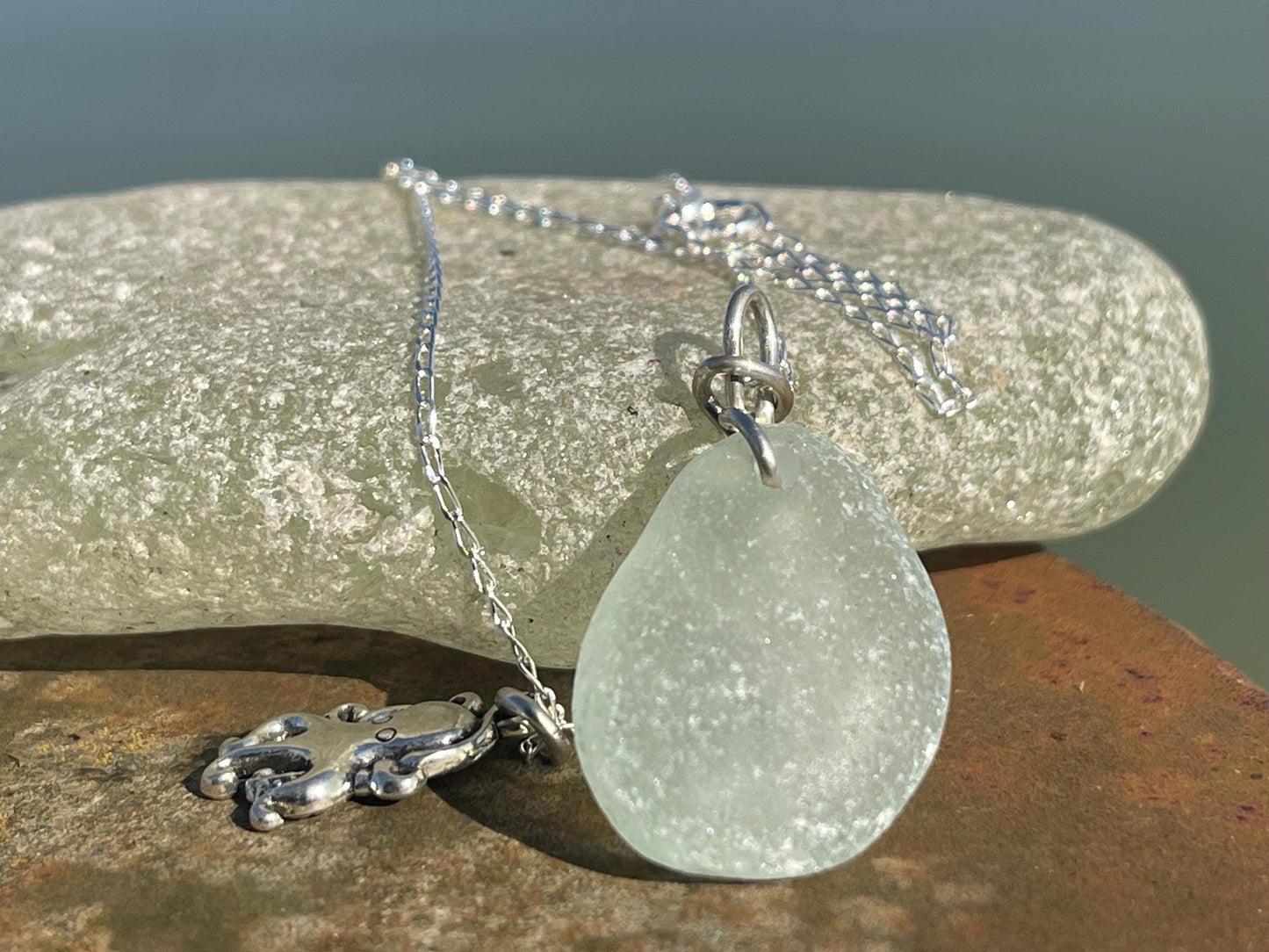 Eco friendly aqua sea glass necklace on a sterling silver chain showcasing a little octopus. Octopus pendant, eco friendly jewellery.