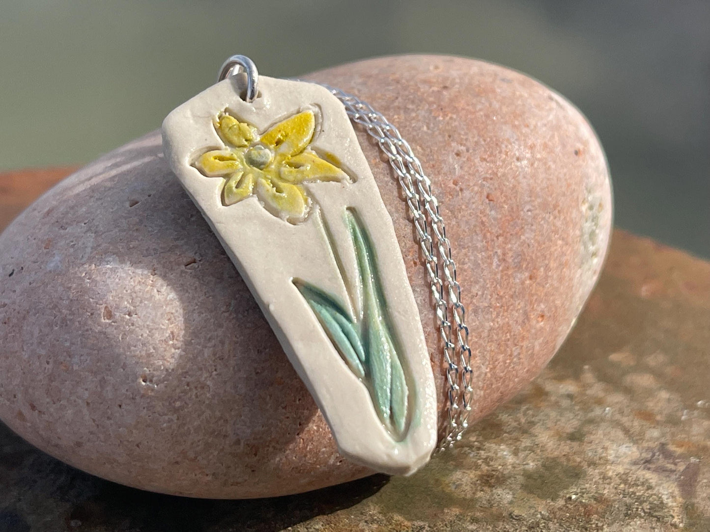 Handmade daffodil necklace. Eco friendly jewellery. Ethical pendants made with waste clay and recycled sterling silver. Ethical jewellery.