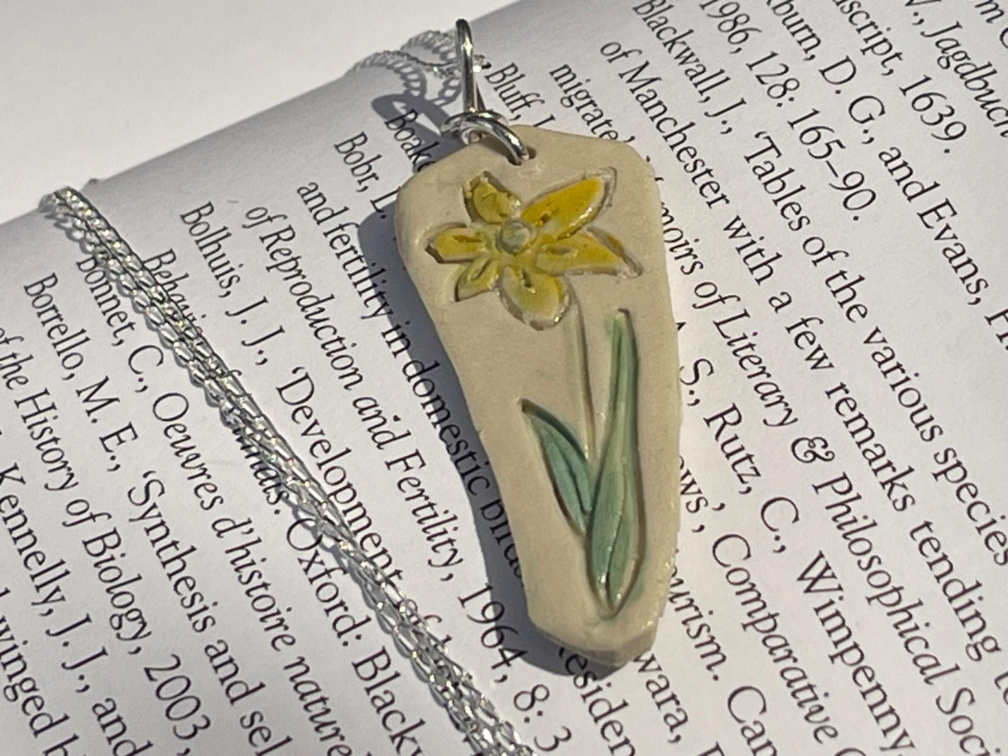 Handmade daffodil necklace. Eco friendly jewellery. Ethical pendants made with waste clay and recycled sterling silver. Ethical jewellery.