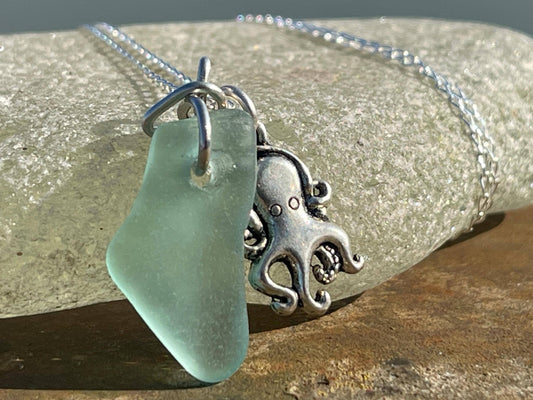 Eco friendly aqua sea glass necklace on a sterling silver chain showcasing a little octopus. Octopus pendant, eco friendly jewellery.
