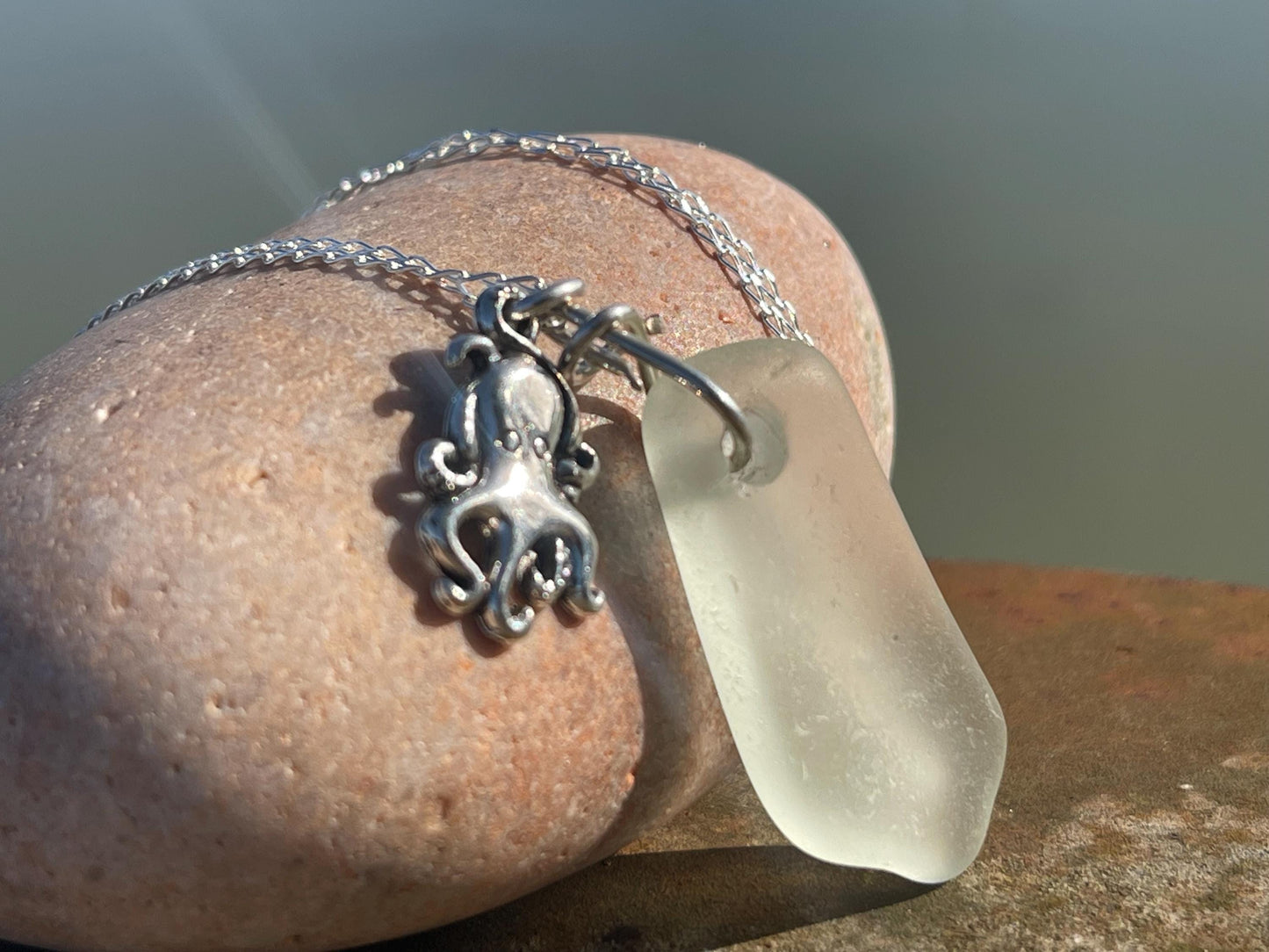 Eco friendly sea glass necklace on a sterling silver chain showcasing a little octopus. Octopus pendant, eco friendly jewellery.