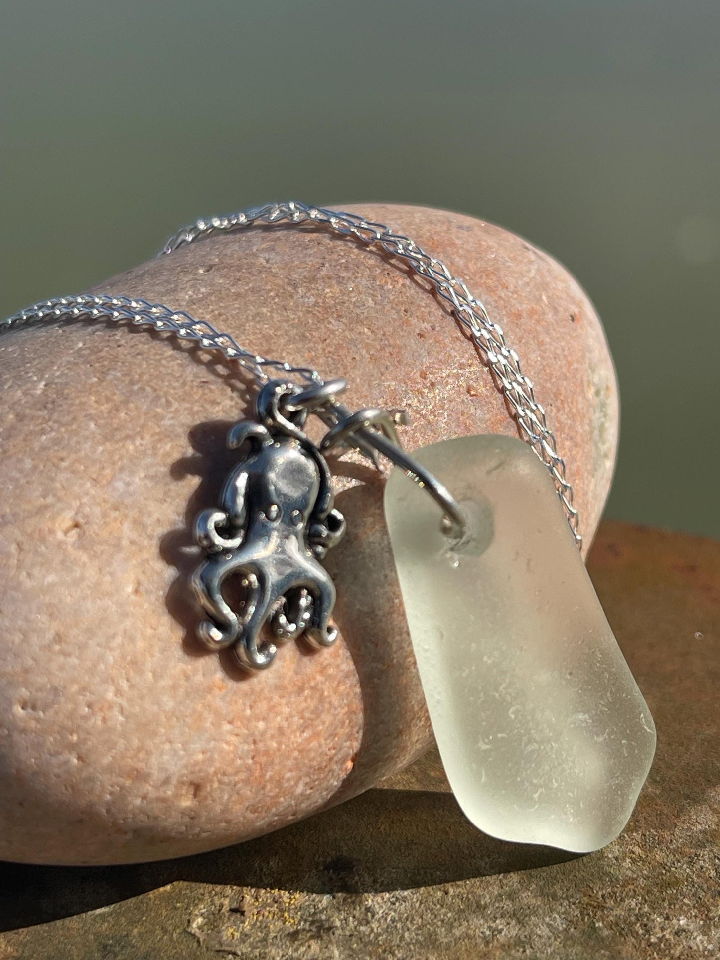Eco friendly sea glass necklace on a sterling silver chain showcasing a little octopus. Octopus pendant, eco friendly jewellery.