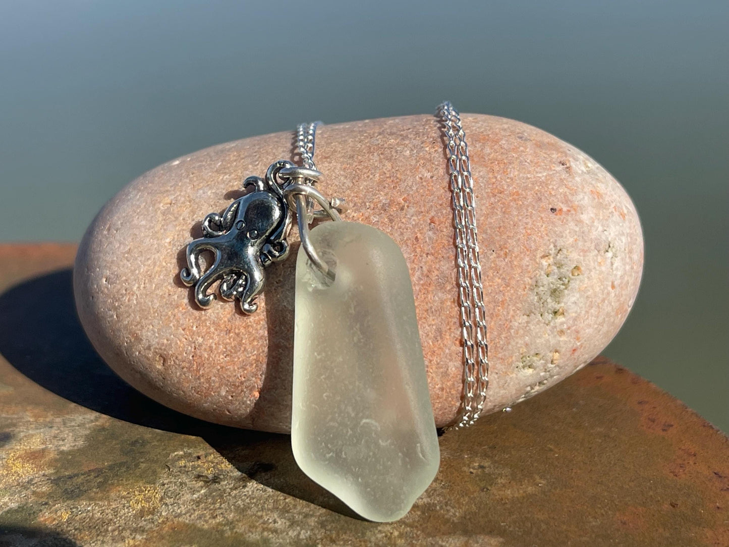 Eco friendly sea glass necklace on a sterling silver chain showcasing a little octopus. Octopus pendant, eco friendly jewellery.