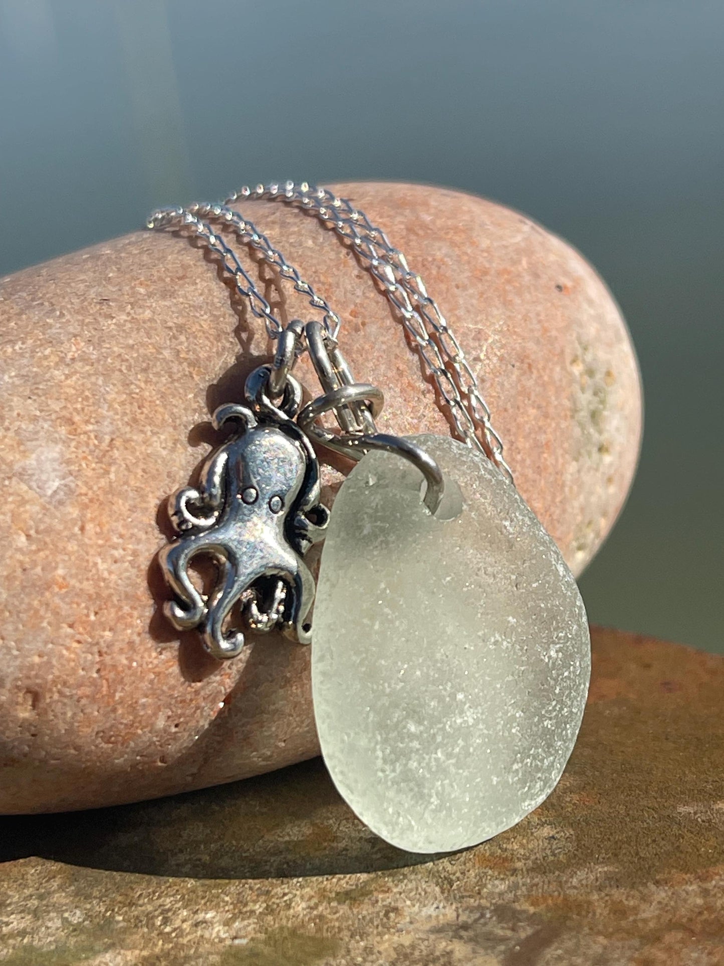 Eco friendly aqua sea glass necklace on a sterling silver chain showcasing a little octopus. Octopus pendant, eco friendly jewellery.
