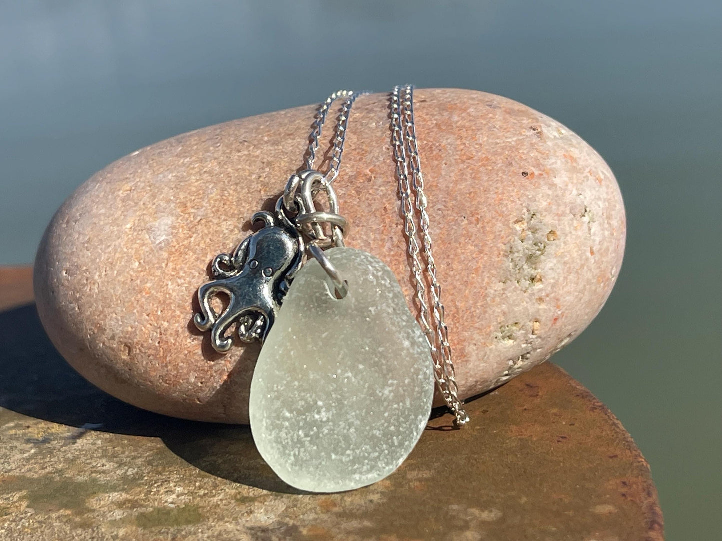 Eco friendly aqua sea glass necklace on a sterling silver chain showcasing a little octopus. Octopus pendant, eco friendly jewellery.
