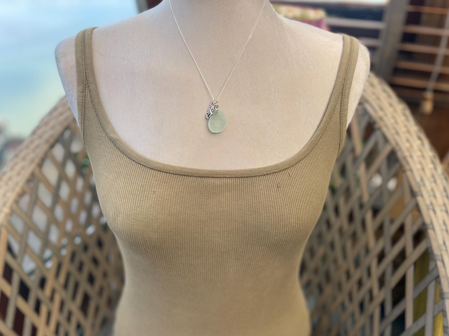 Eco friendly aqua sea glass necklace on a sterling silver chain showcasing a little octopus. Octopus pendant, eco friendly jewellery.