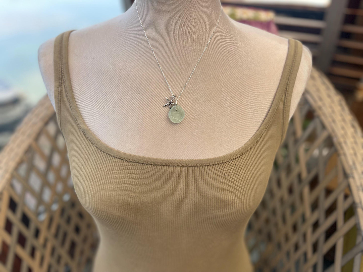 Eco friendly white sea glass necklace on a sterling silver chain showcasing a little starfish. Starfish pendant, eco friendly jewellery.