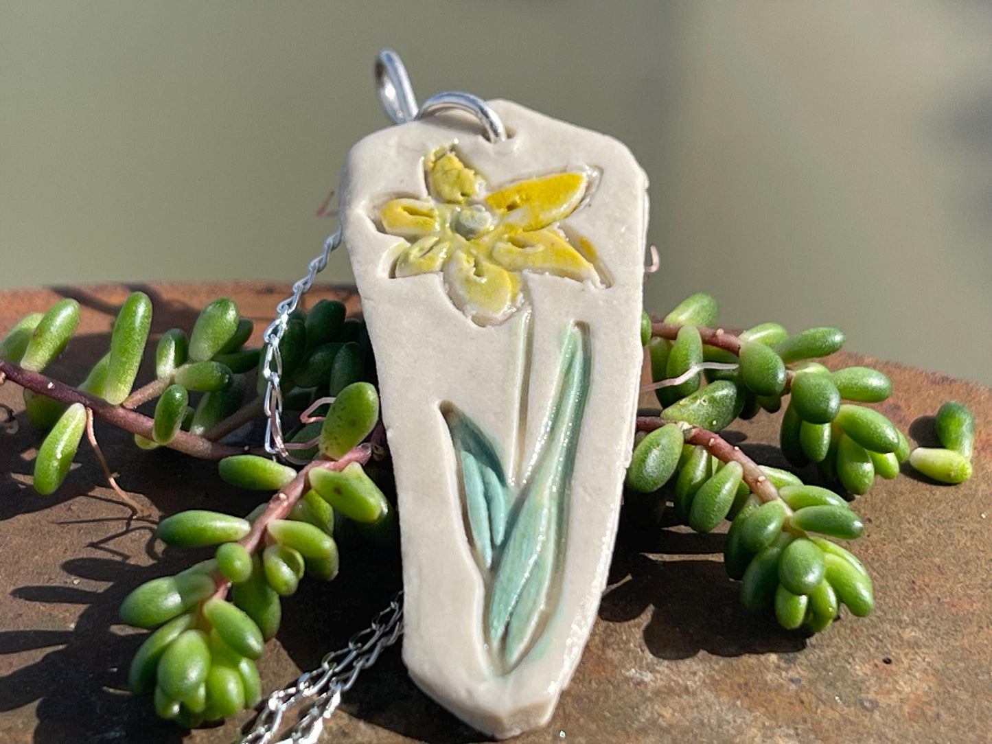 Handmade daffodil necklace. Eco friendly jewellery. Ethical pendants made with waste clay and recycled sterling silver. Ethical jewellery.