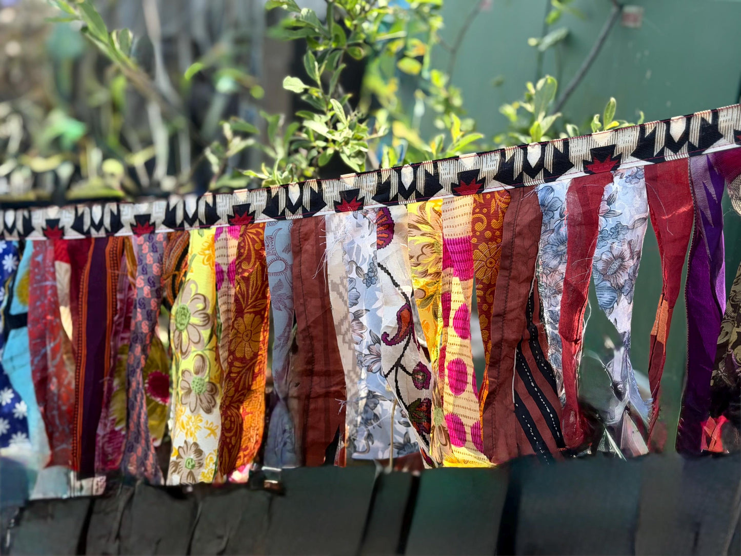 Long strips of multi-coloured rag bunting. Party bunting, wedding bunting, recycled sari bunting. Ideal for festivals, camping, birthdays