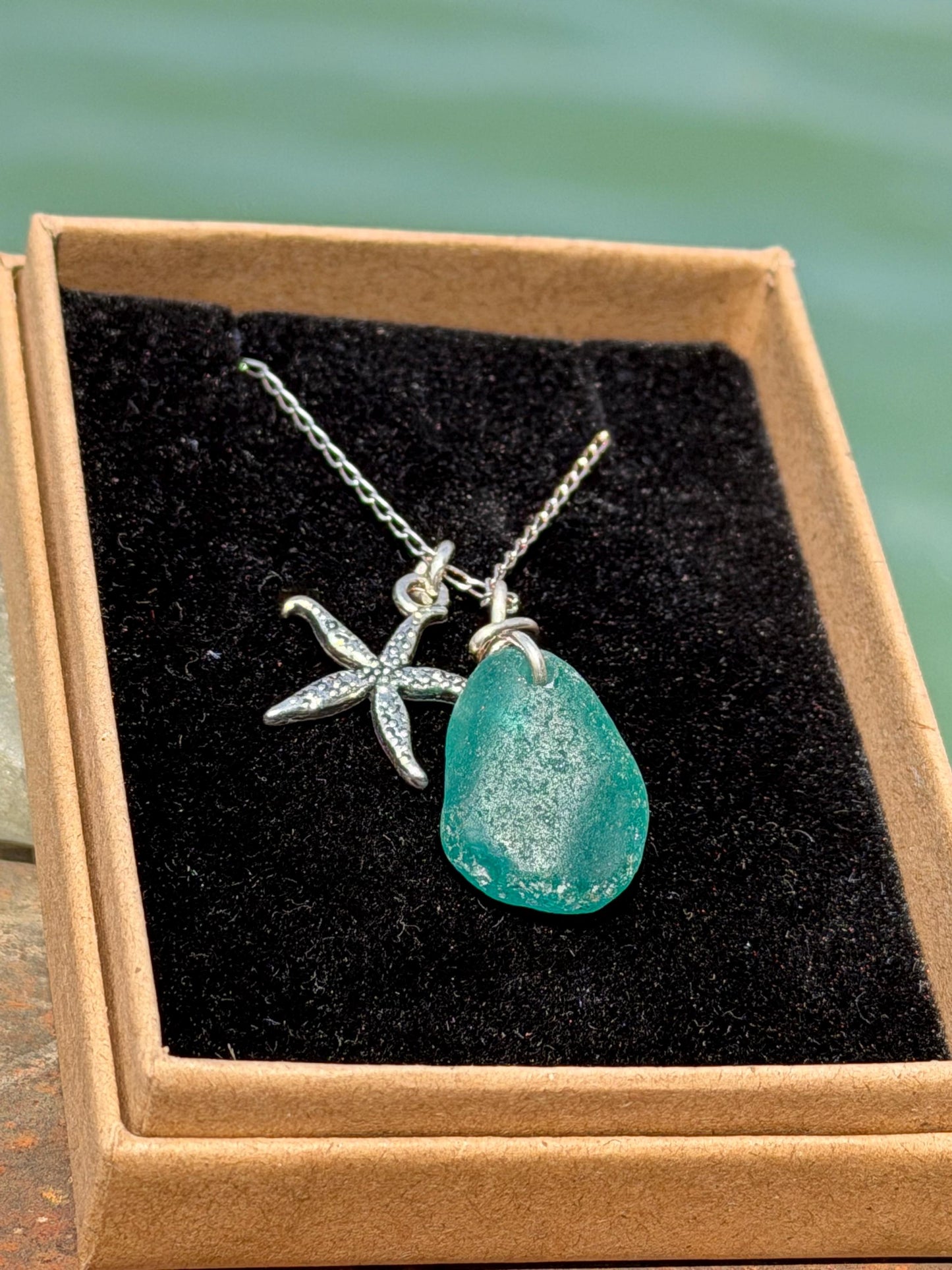 Eco friendly turquoise sea glass necklace on a sterling silver chain showcasing a little starfish. Starfish pendant, eco friendly jewellery.