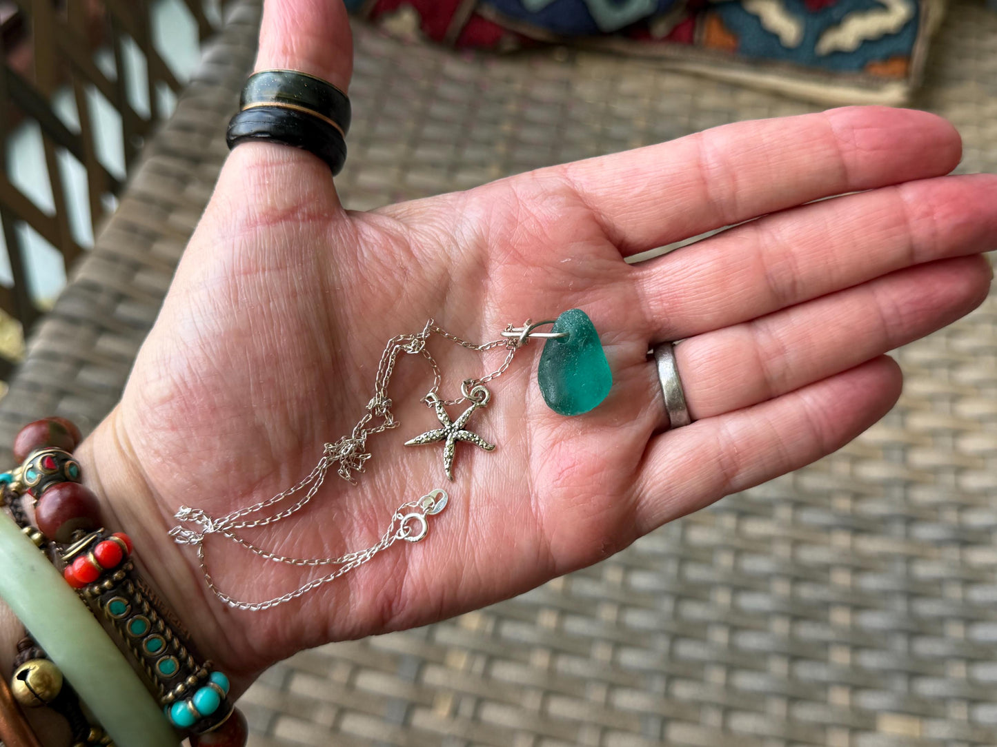 Eco friendly turquoise sea glass necklace on a sterling silver chain showcasing a little starfish. Starfish pendant, eco friendly jewellery.
