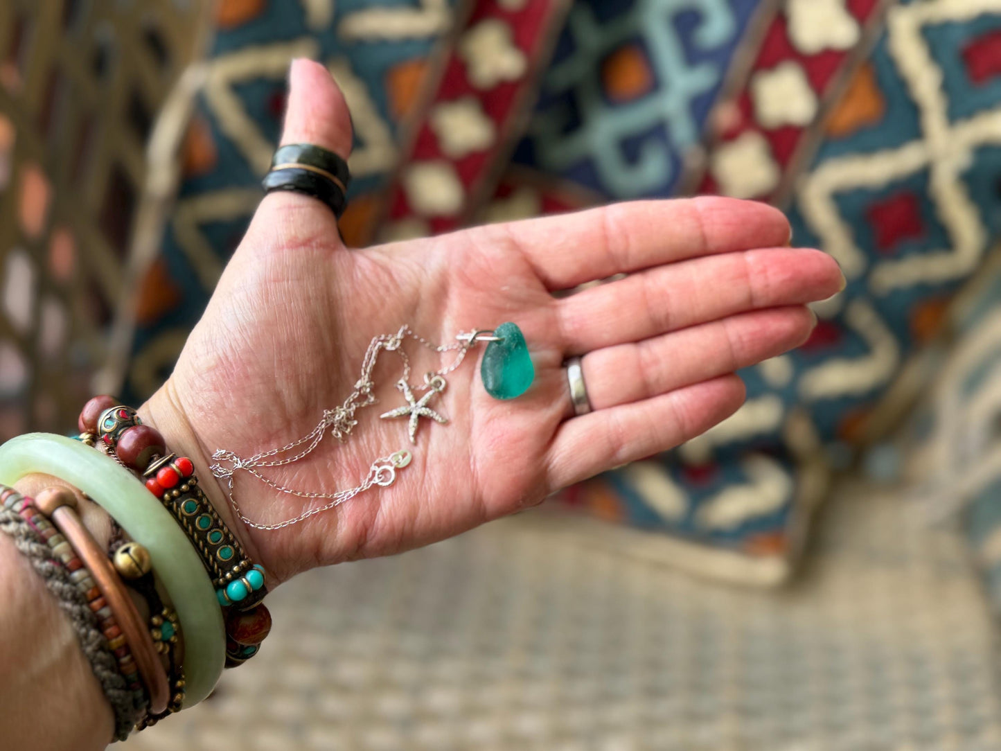 Eco friendly turquoise sea glass necklace on a sterling silver chain showcasing a little starfish. Starfish pendant, eco friendly jewellery.