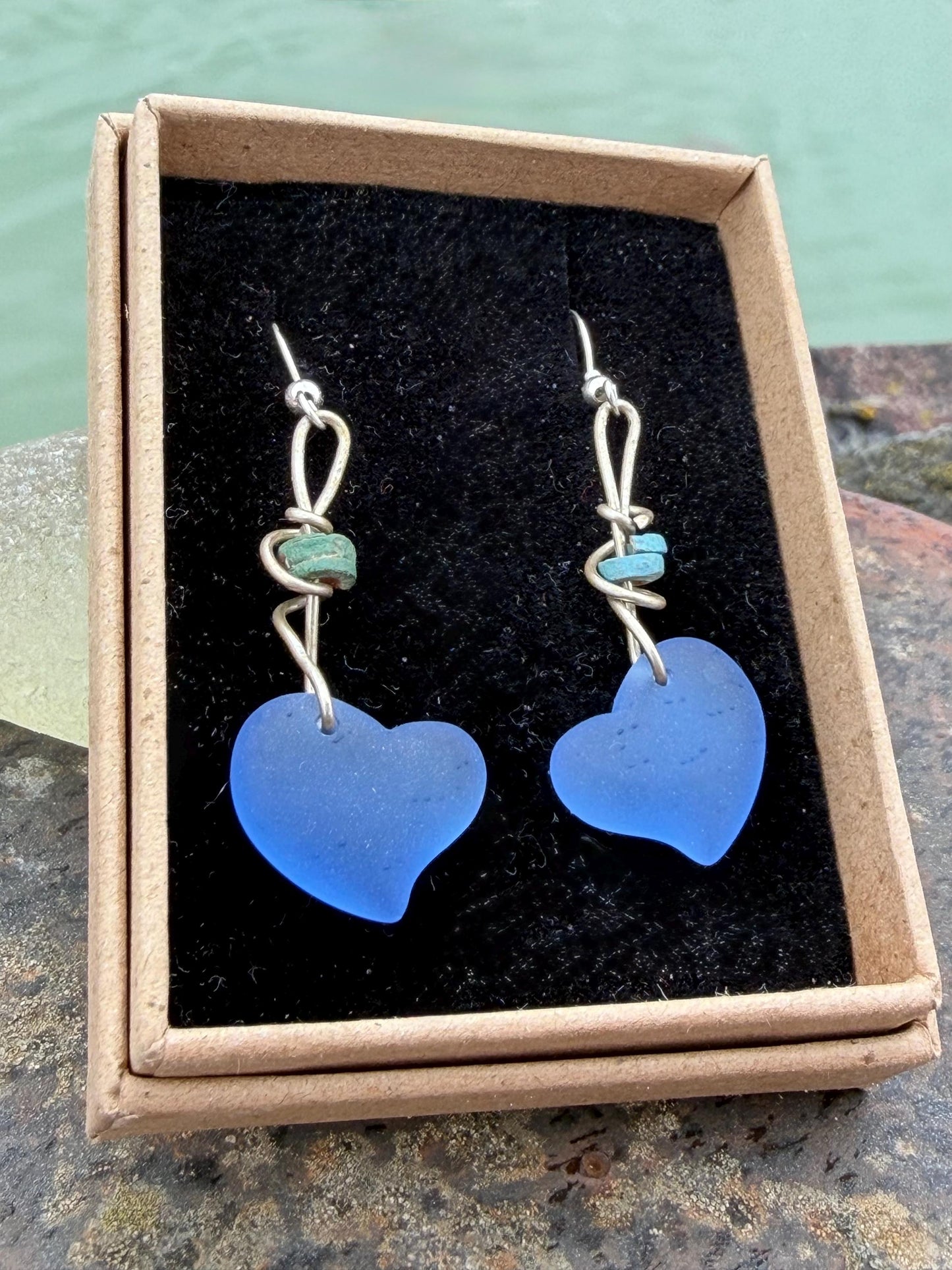 Blue glass heart earrings on recycled sterling silver. Eco conscious jewellery. Ethical jewellery. Blue glass hearts. Handmade earrings