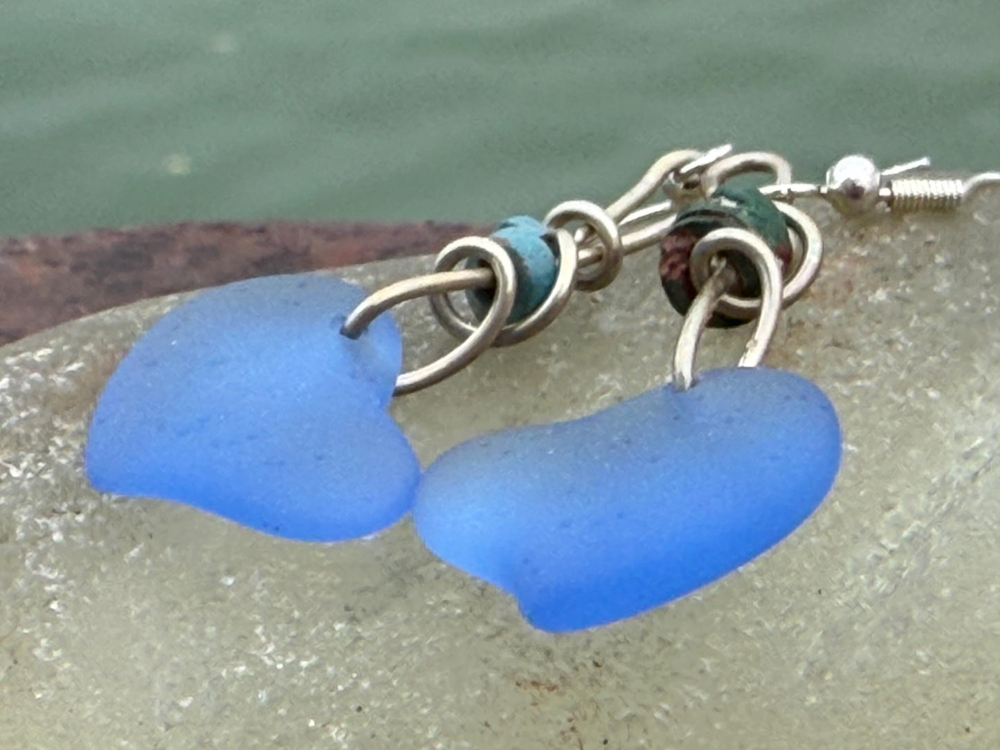 Blue glass heart earrings on recycled sterling silver. Eco conscious jewellery. Ethical jewellery. Blue glass hearts. Handmade earrings