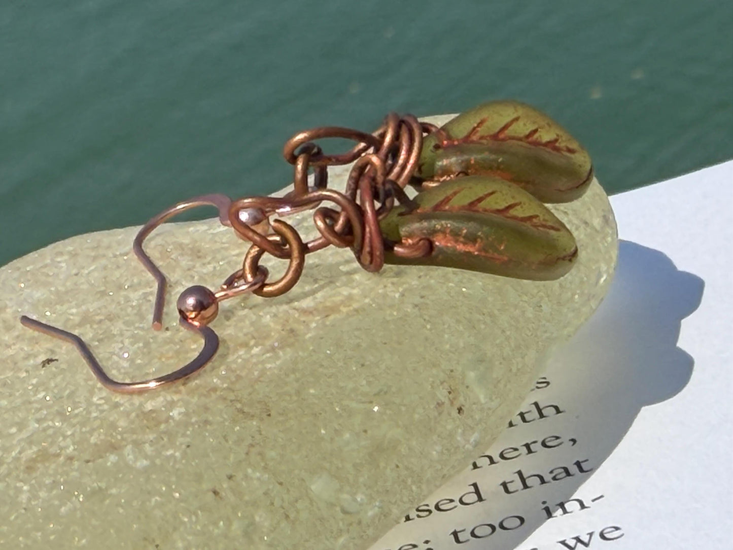 Upcycled glass leaves wrapped in recycled copper. Held on rose gold ear hooks. Eco friendly jewellery. Unique earrings. Leaf earrings.