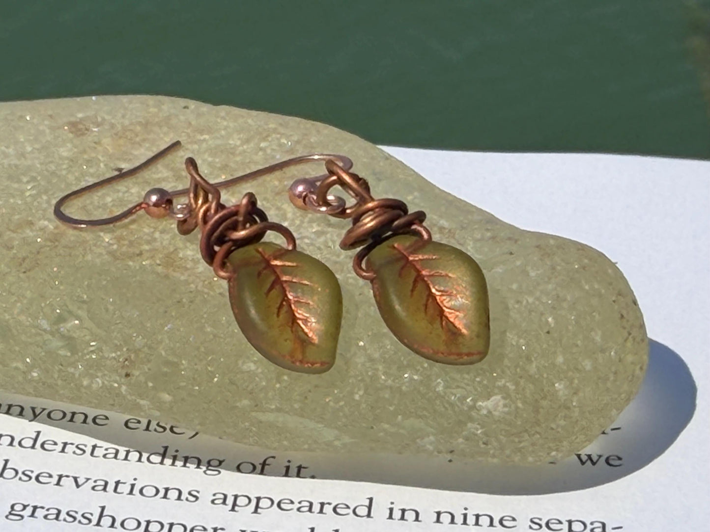 Upcycled glass leaves wrapped in recycled copper. Held on rose gold ear hooks. Eco friendly jewellery. Unique earrings. Leaf earrings.
