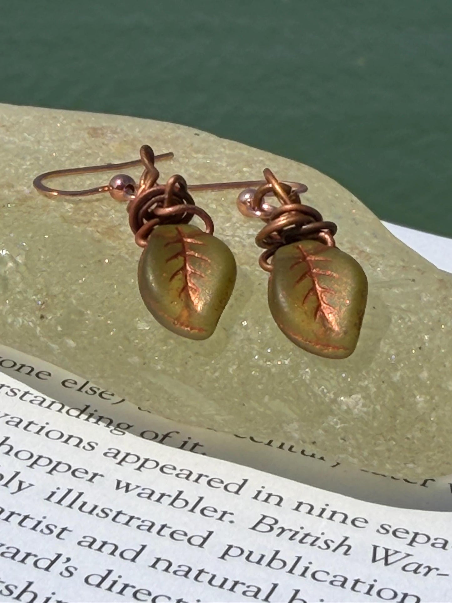 Upcycled glass leaves wrapped in recycled copper. Held on rose gold ear hooks. Eco friendly jewellery. Unique earrings. Leaf earrings.